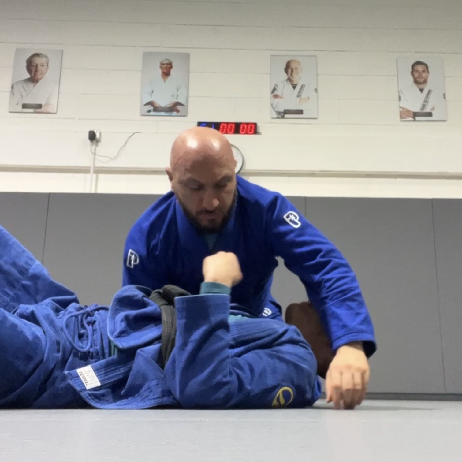 Olgun Tiltay learning basics of Brazilian Jiu-Jitsu from Chris Ong [2nd Dan] BJJ Coach at Roger Gracie Academy